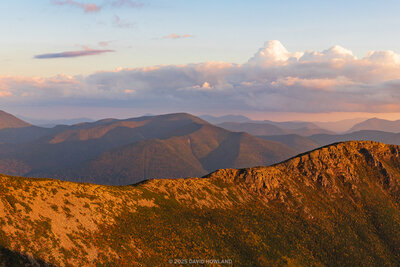 A panoramic photo of the rocky ridgeline of Bondcliff bathed in golden sunset light.